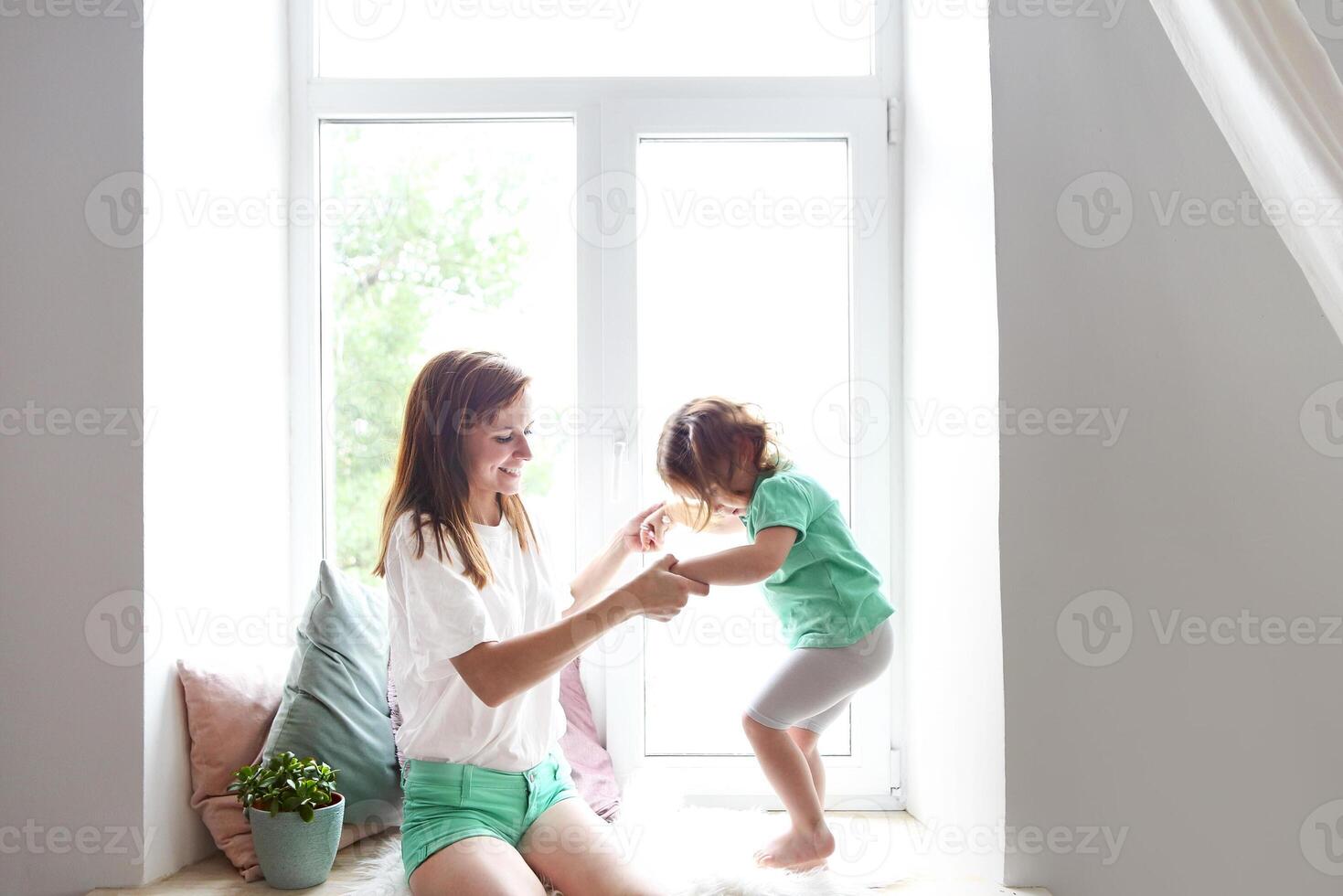 Young woman having fun with daughter photo