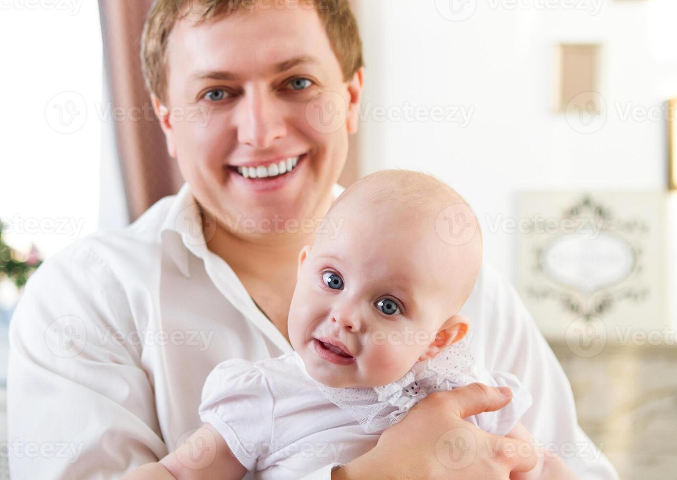Happy smiling father with six month old baby girl photo
