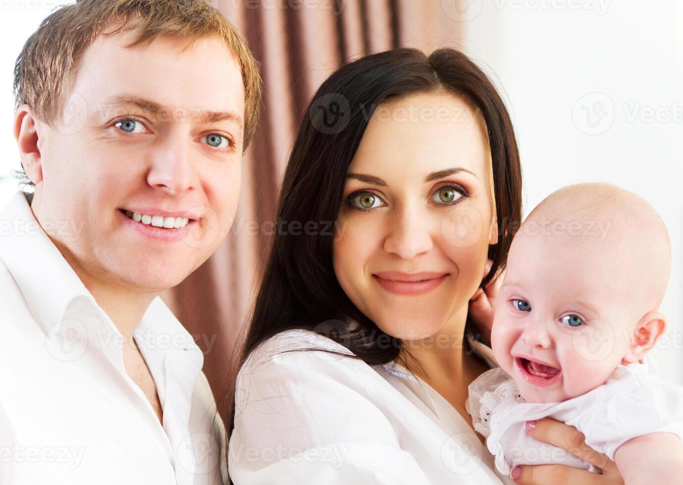 Happy smiling family with little baby girl photo