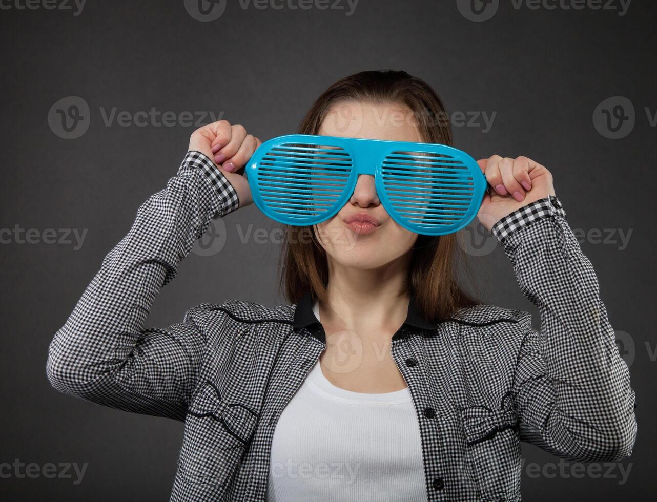 Portrait of the teen girl with crazy glasses photo