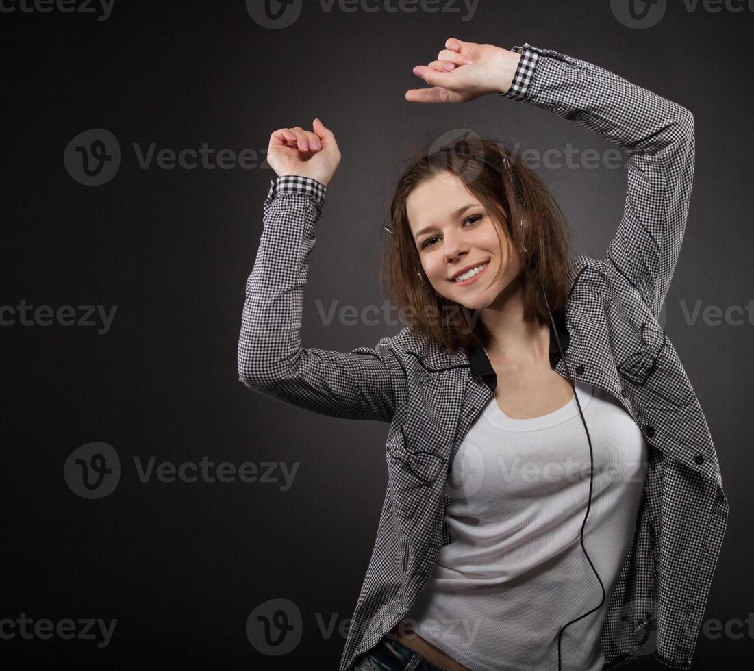 Portrait of the dancing girl wearing headphones photo