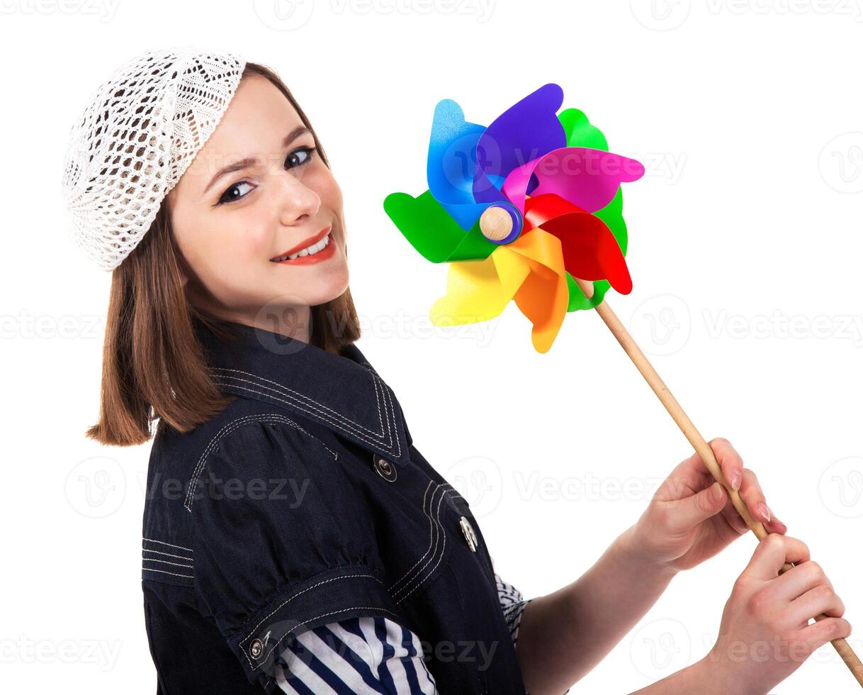Young cute brunette girl with wind turbine toy photo