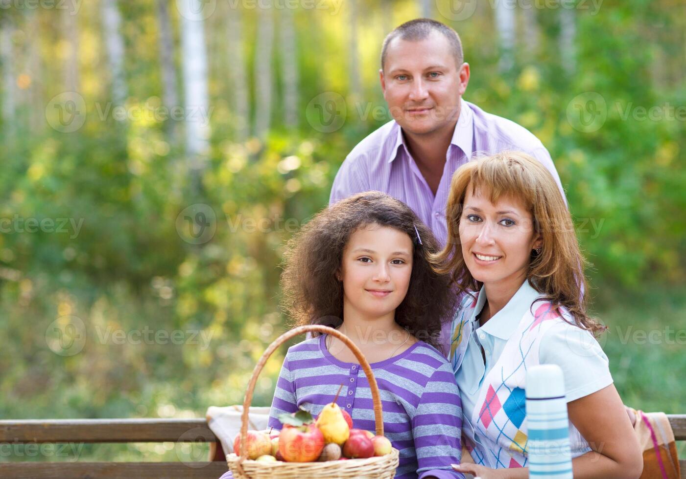 Happy family with daughter on autumn picnic photo