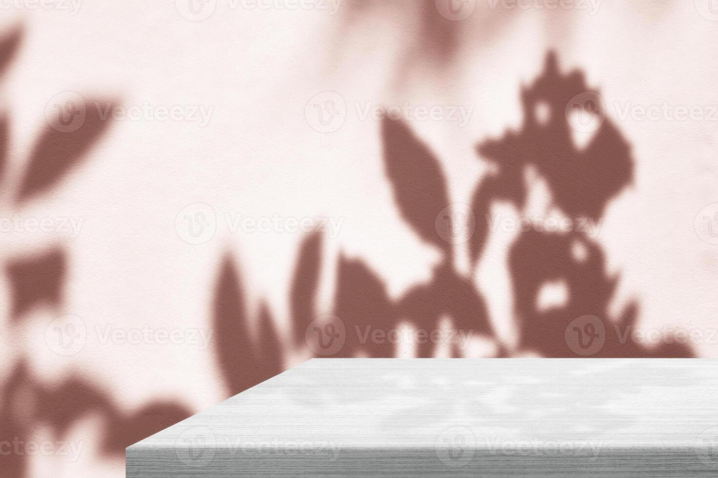Minimal White Wooden Table Corner with Shadow and Pink Light Beam on Concrete Wall Background photo