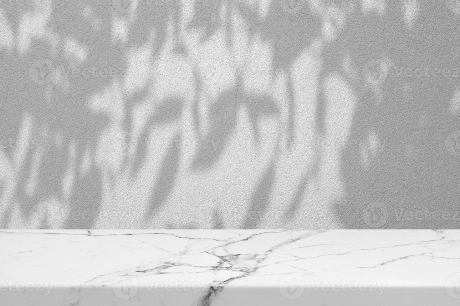 White Marble Table with Tree Shadow on Concrete Wall Texture Background photo
