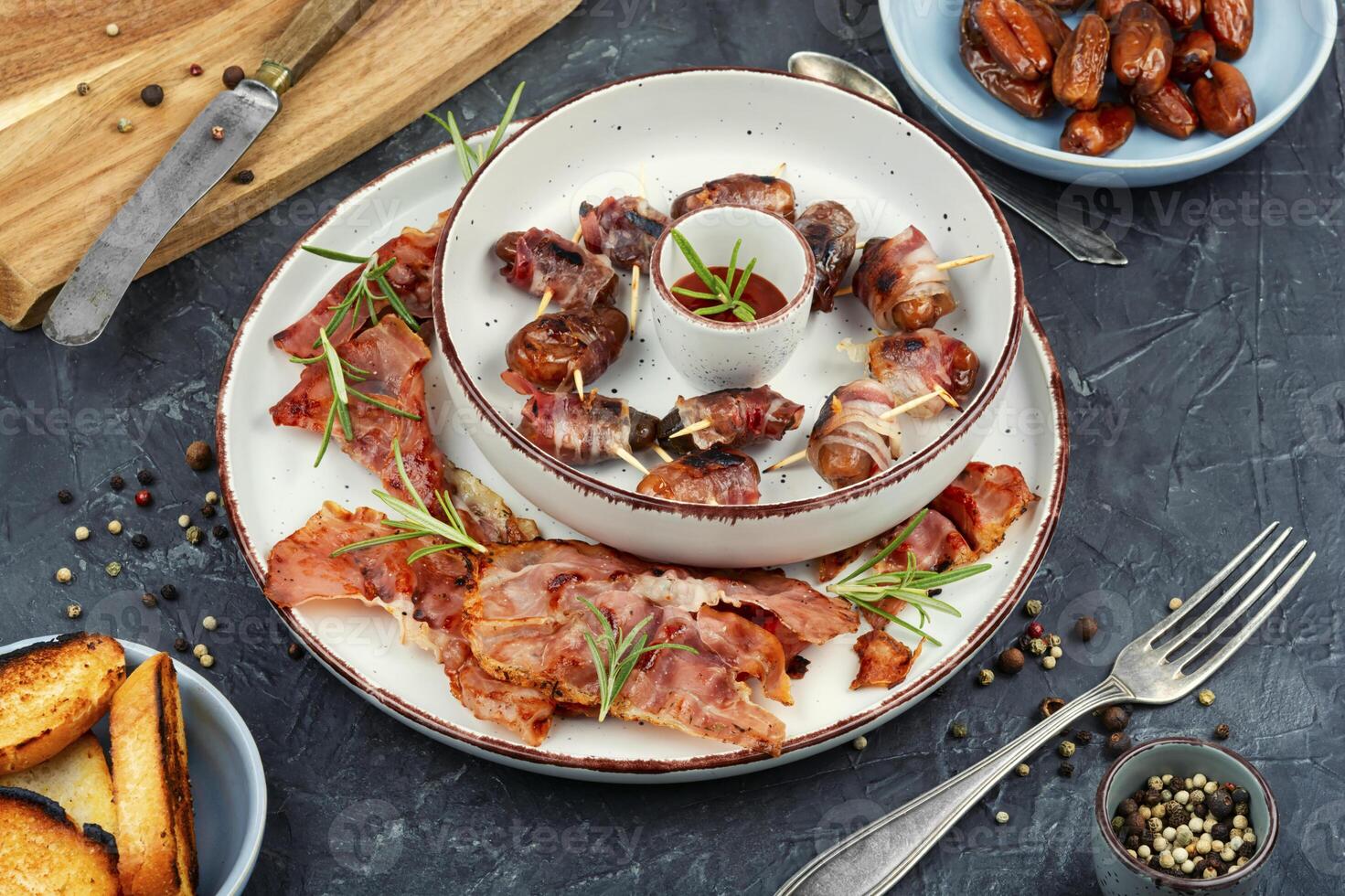 A plate of bacon wrapped dates. photo