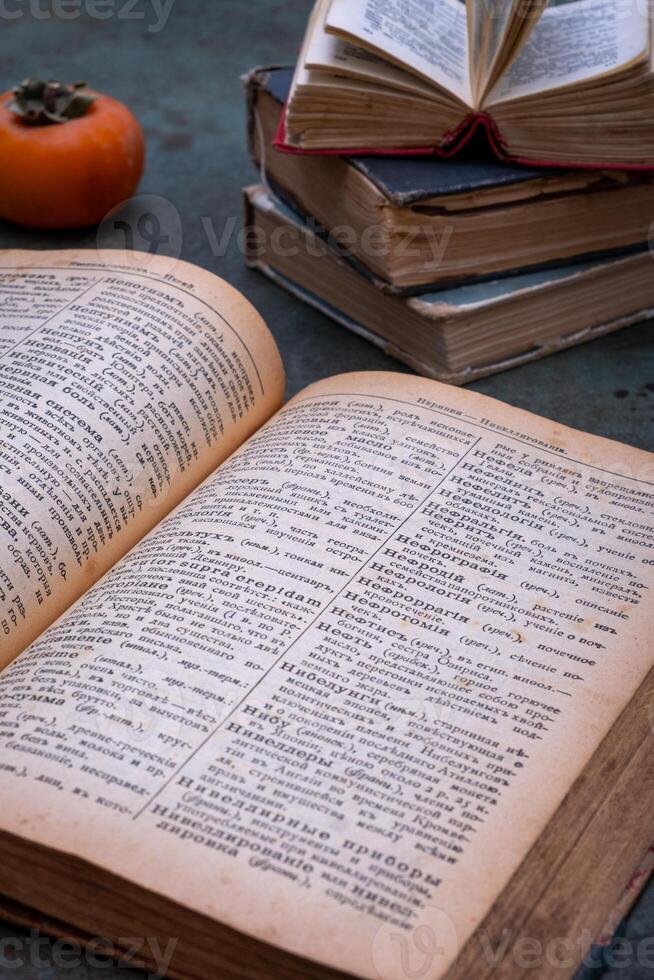 Close-up of several old dictionaries against a dark background. Selective focus photo