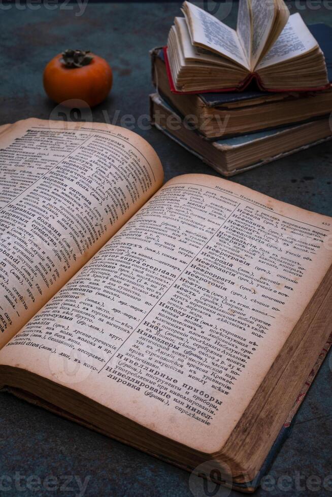 Close-up of several old dictionaries against a dark background. Selective focus photo