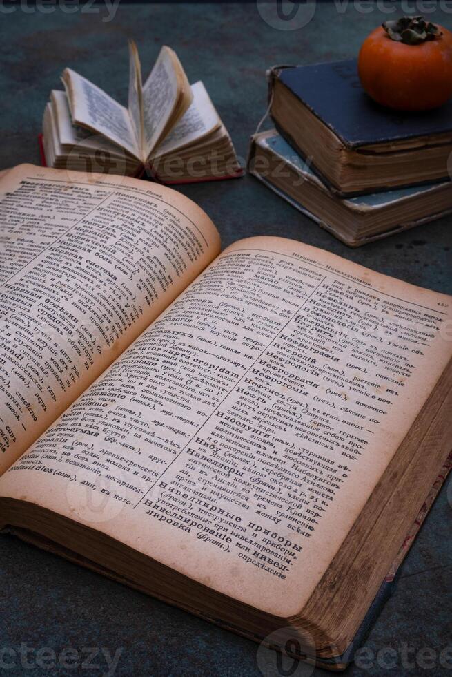 Close-up of several old dictionaries against a dark background. Selective focus photo