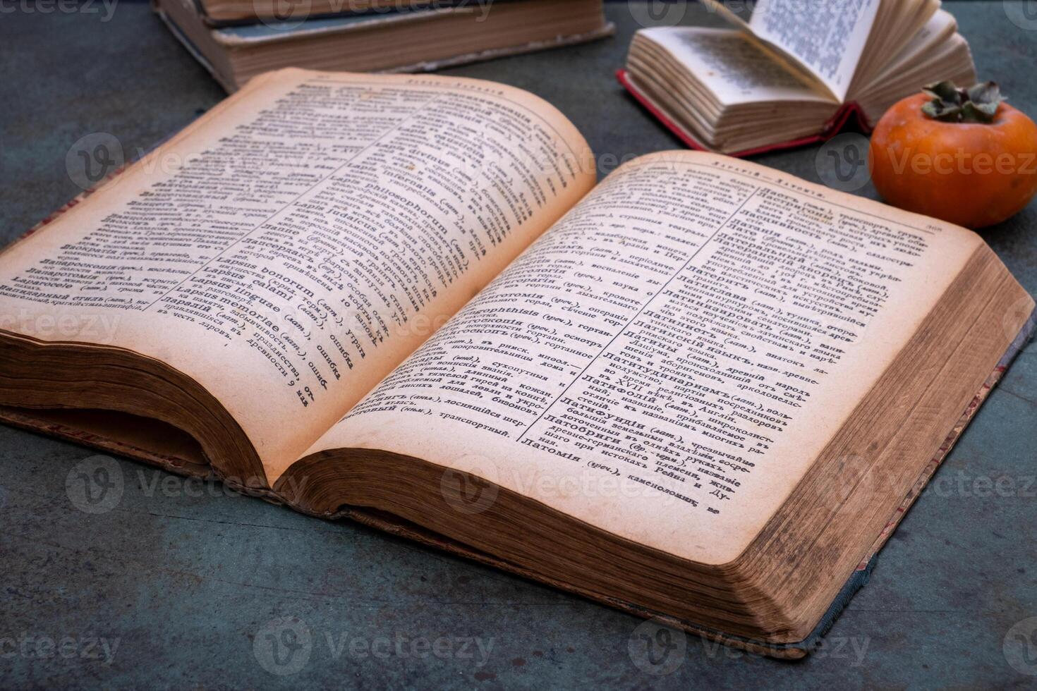 Close-up of several old dictionaries against a dark background. Selective focus photo