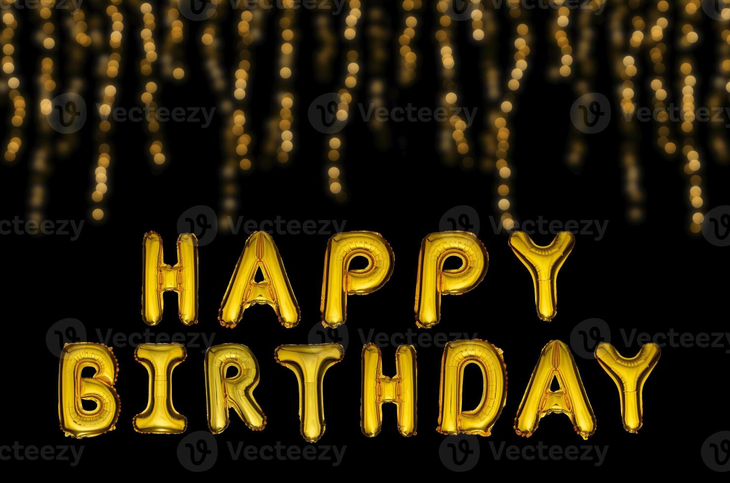 Happy birthday balloons in gold letters on a black festive background. photo