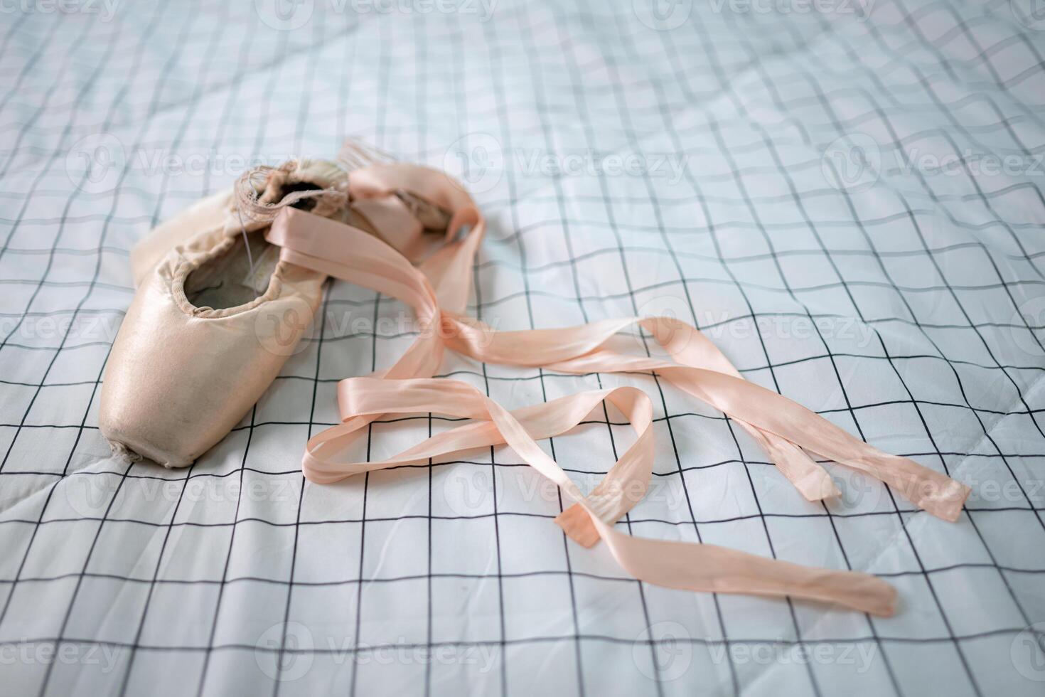 Ballet shoes on the bed, Prepared for a girl ballet students to practice ballet dancing at home photo