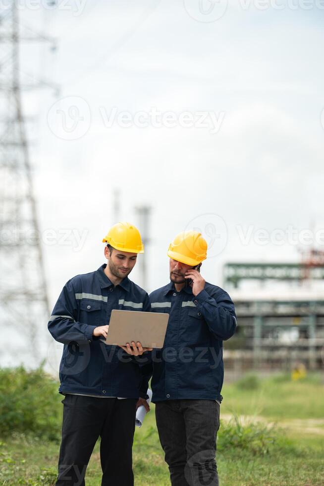 Both of Petroleum engineer is on a mission to inspect oil distillation at a huge oil refinery photo