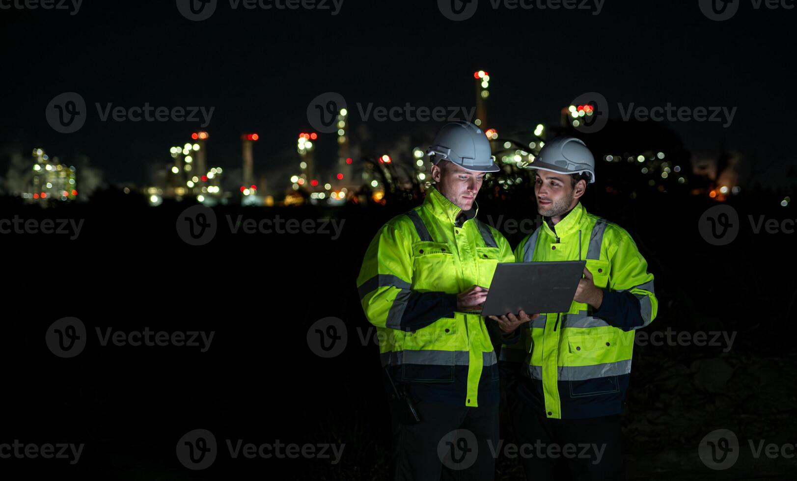 Both of Petroleum engineer is on a mission to inspect oil distillation at a huge oil refinery photo