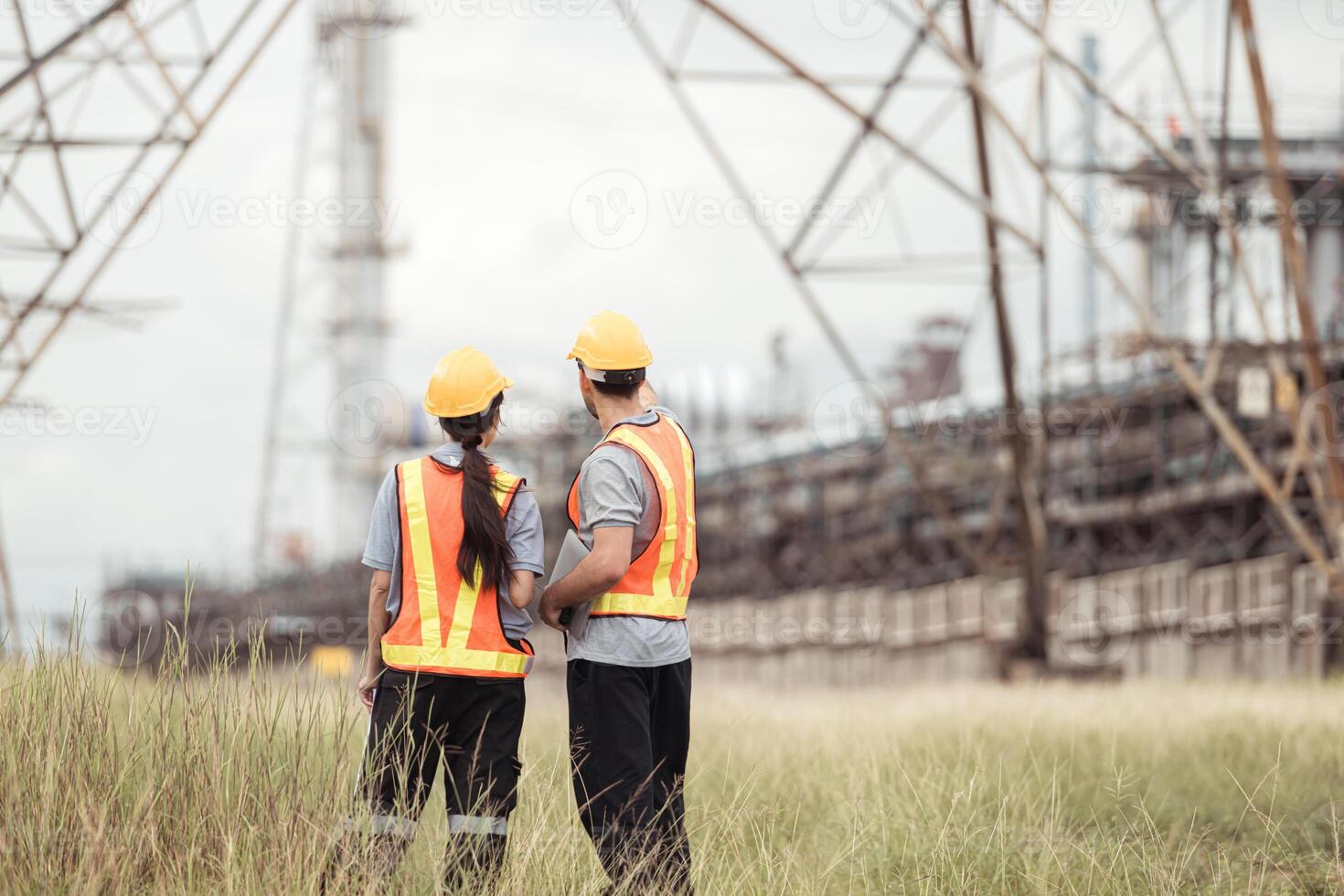 Both of Petroleum engineer is on a mission to inspect oil distillation at a huge oil refinery photo
