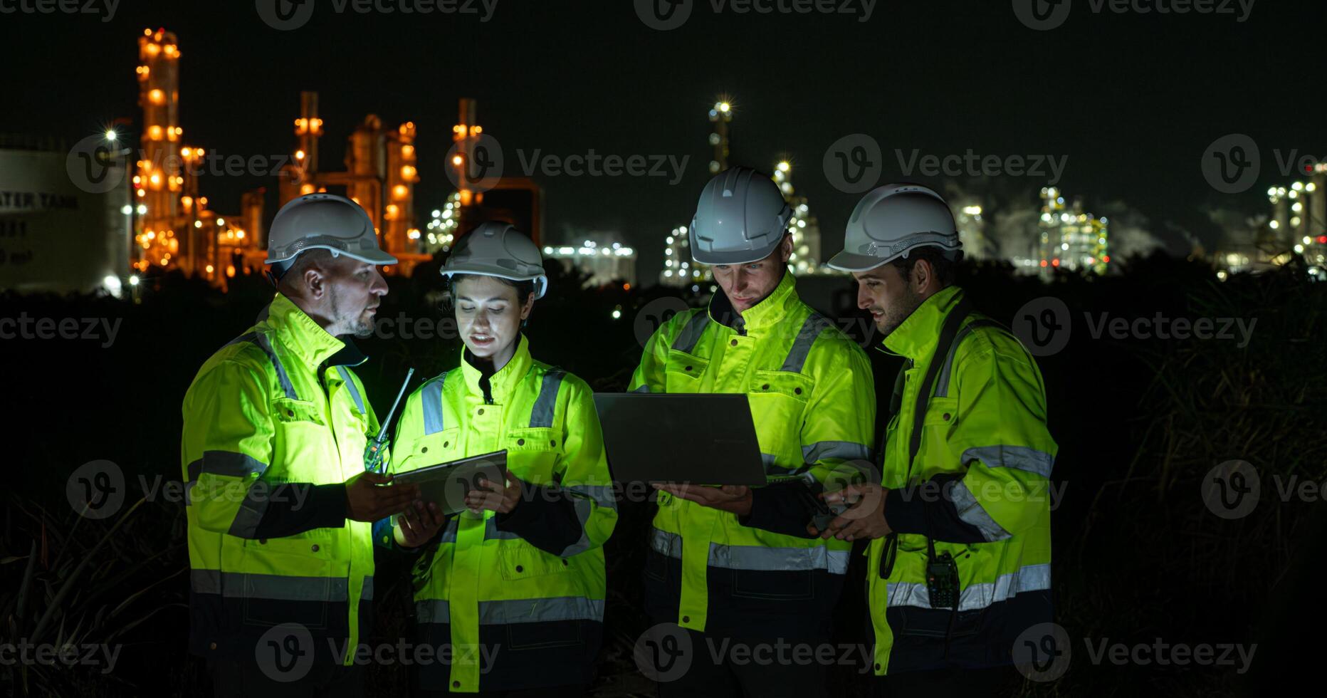 Group of Petroleum engineer is on a mission to inspect oil distillation at a huge oil refinery photo
