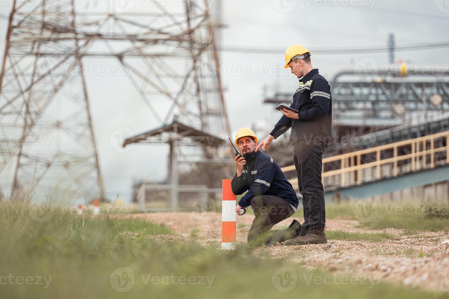 Both of Petroleum engineer is on a mission to inspect oil distillation at a huge oil refinery photo