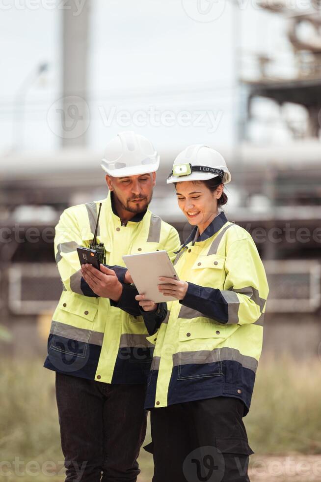 Both of Petroleum engineer is on a mission to inspect oil distillation at a huge oil refinery photo