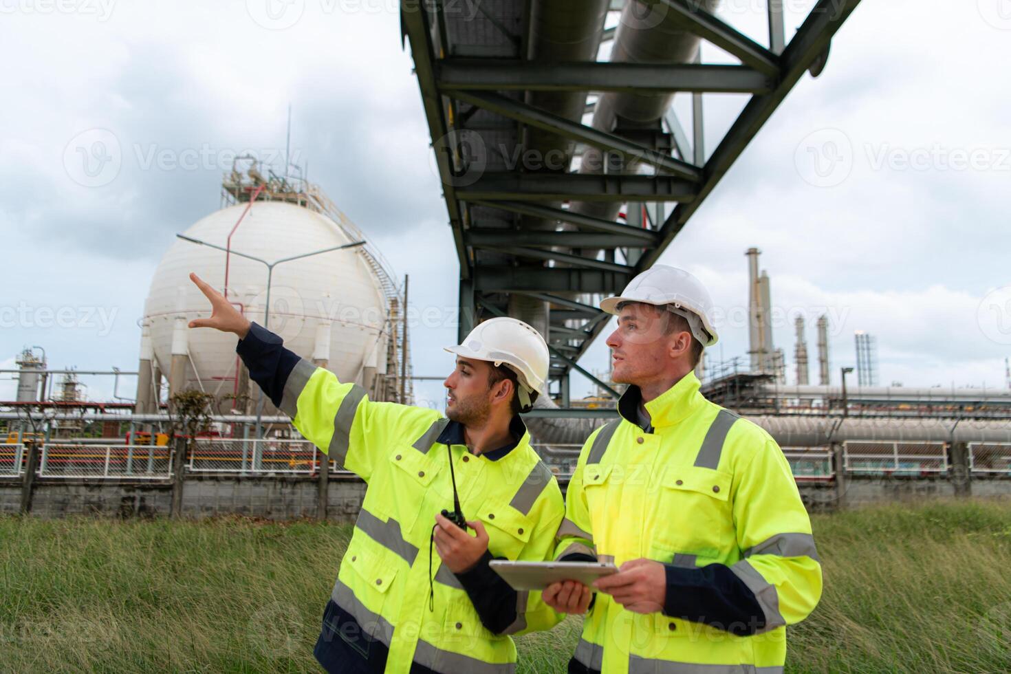 Both of Petroleum engineer is on a mission to inspect oil distillation at a huge oil refinery photo