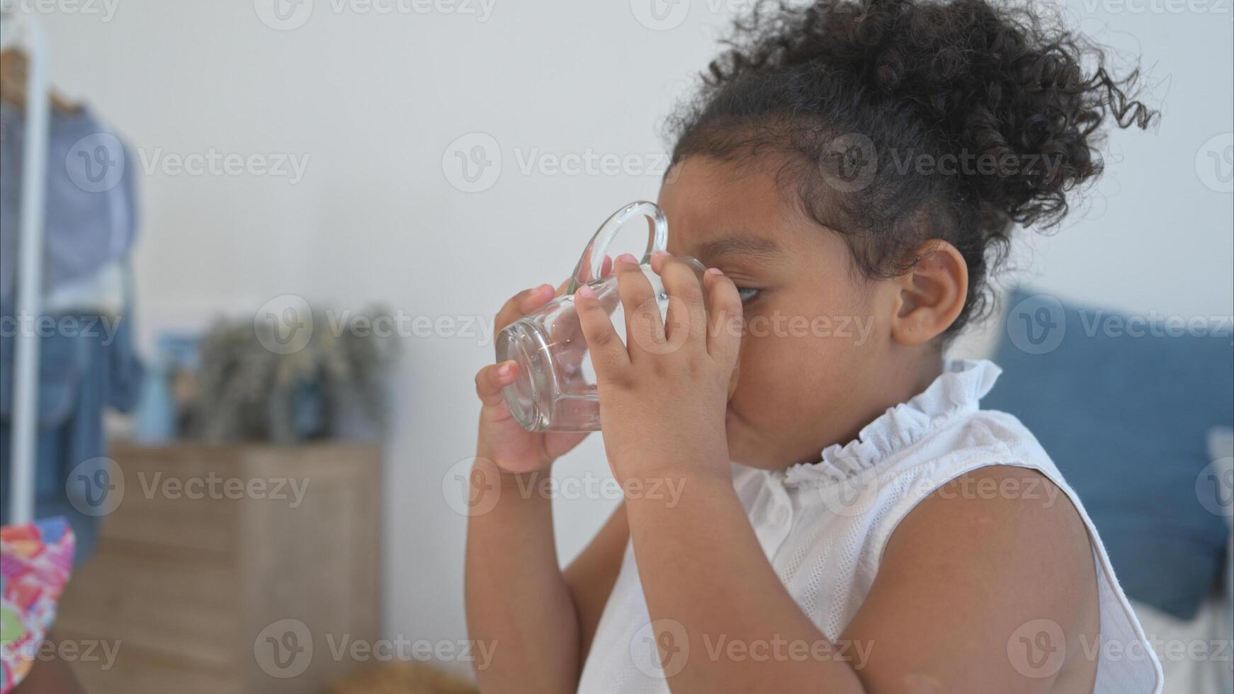 A tiny girl drink milk before bed in the bedroom photo