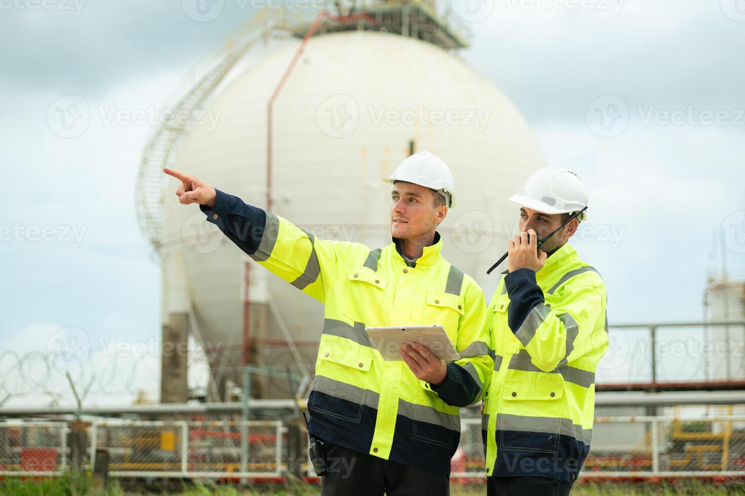 Both of Petroleum engineer is on a mission to inspect oil distillation at a huge oil refinery photo