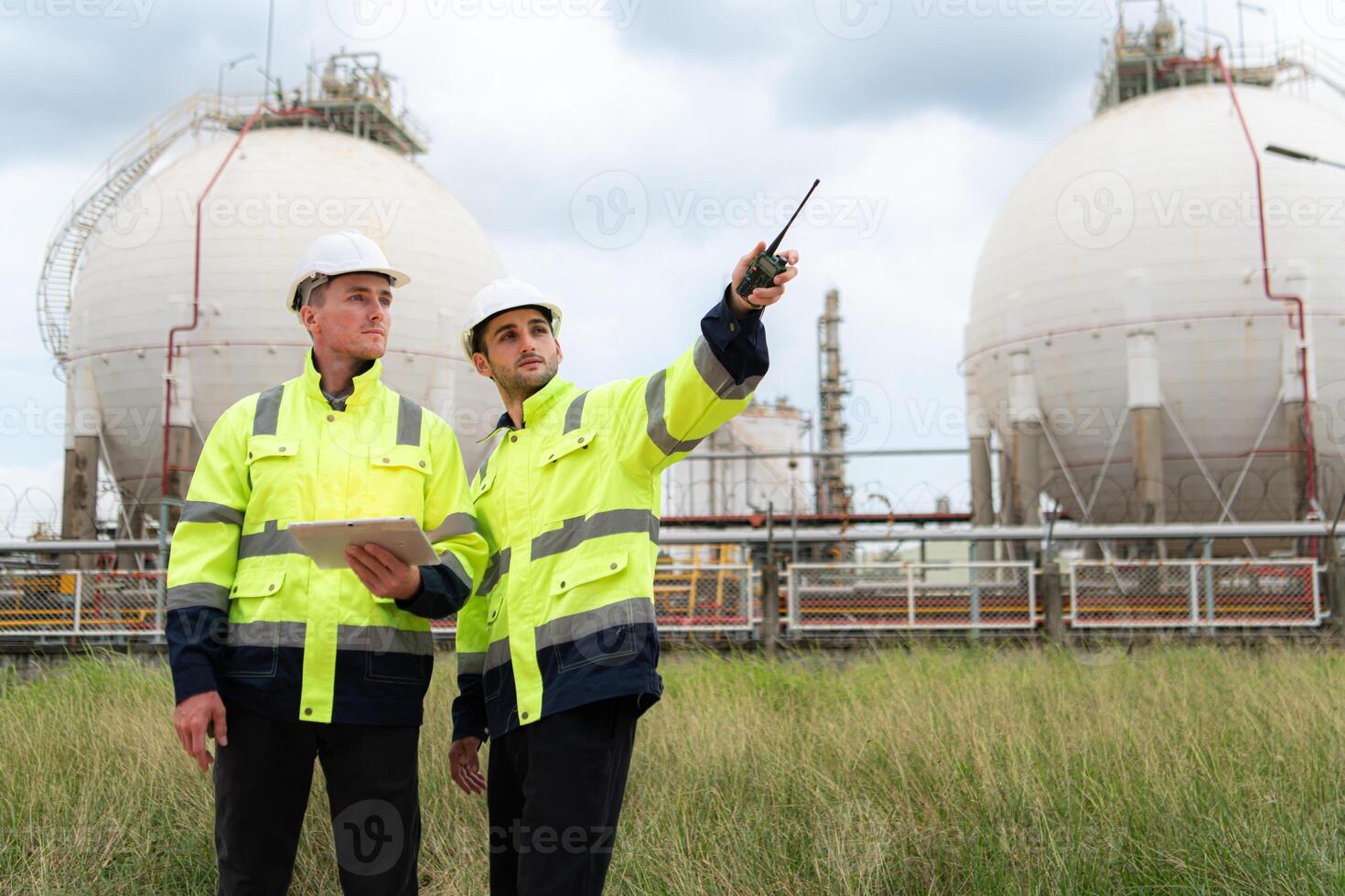 Both of Petroleum engineer is on a mission to inspect oil distillation at a huge oil refinery photo