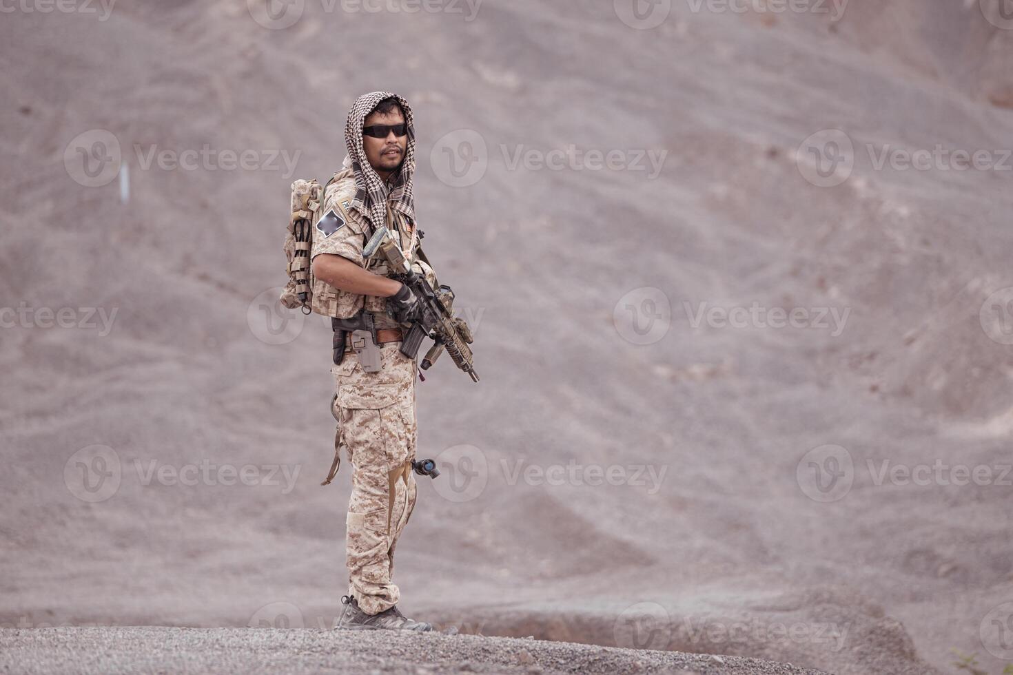 Soldiers in camouflage military uniforms carrying weapons, Reconnaissance missions in rugged mountains, Assault infantry battle training. photo
