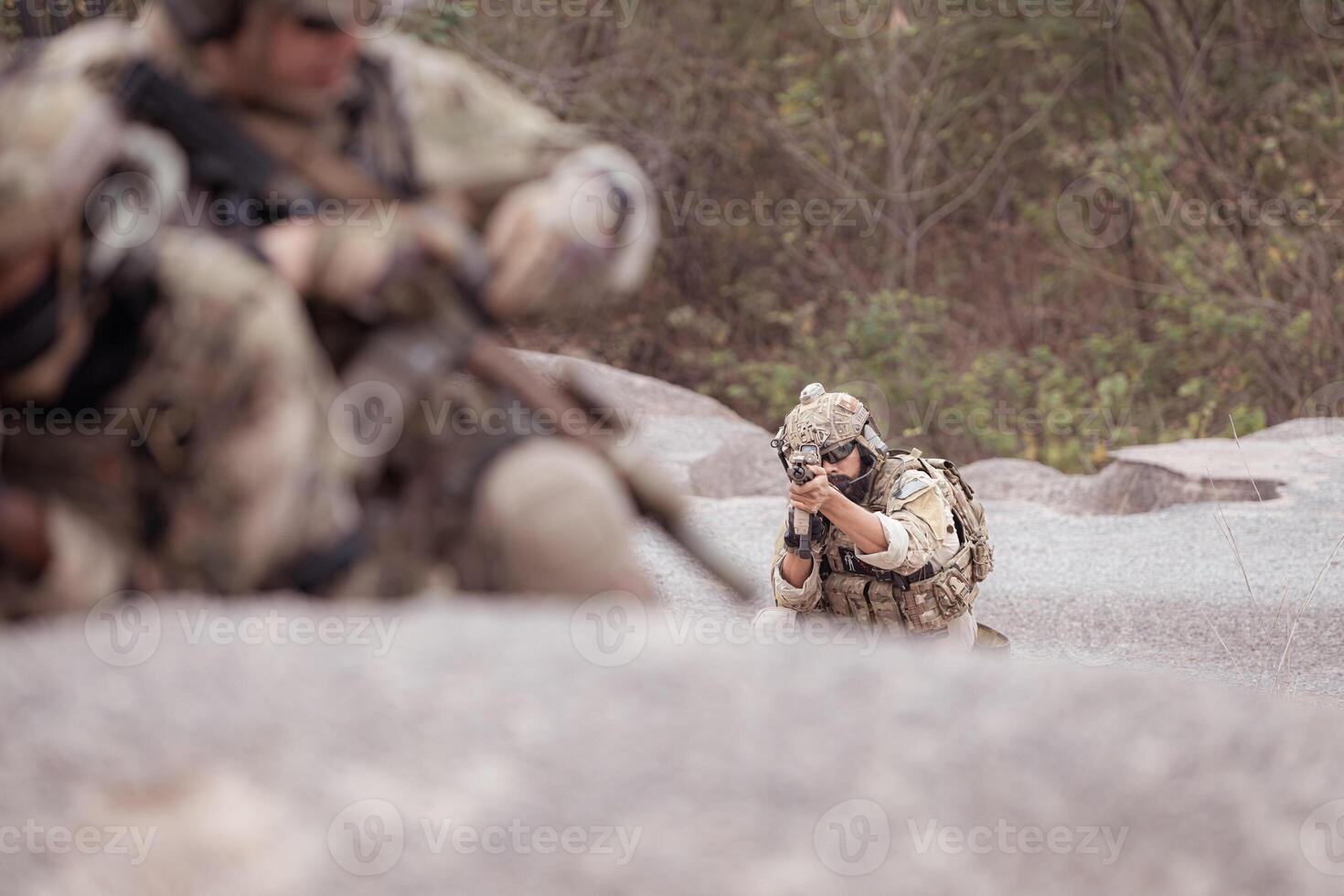 Soldiers in camouflage military uniforms carrying weapons, Reconnaissance missions in rugged mountains, Assault infantry battle training. photo