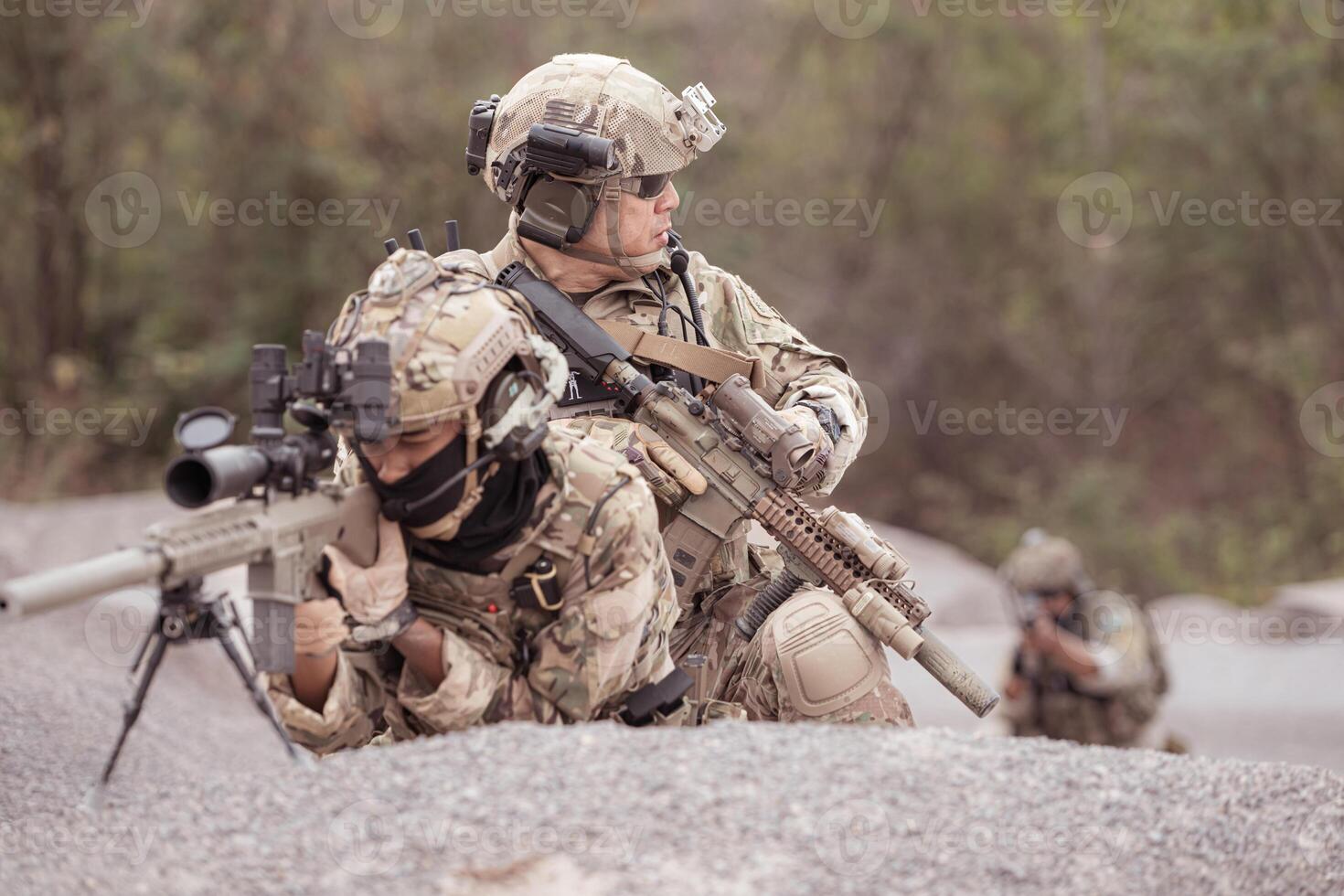 Soldiers in camouflage military uniforms carrying weapons, Reconnaissance missions in rugged mountains, Assault infantry battle training. photo