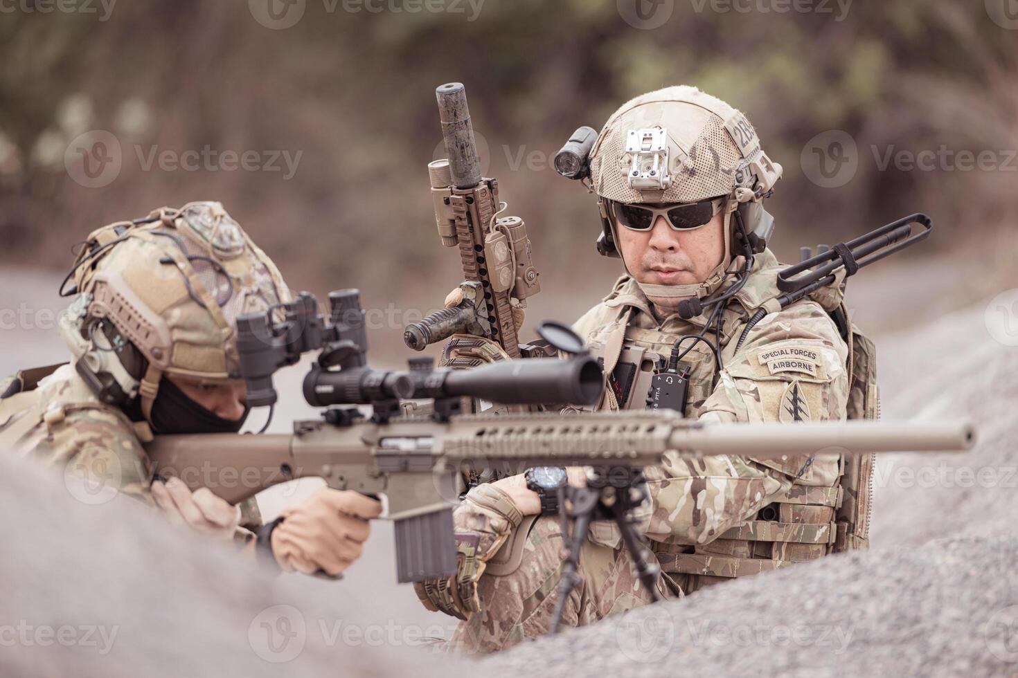 Soldiers in camouflage military uniforms carrying weapons, Reconnaissance missions in rugged mountains, Assault infantry battle training. photo