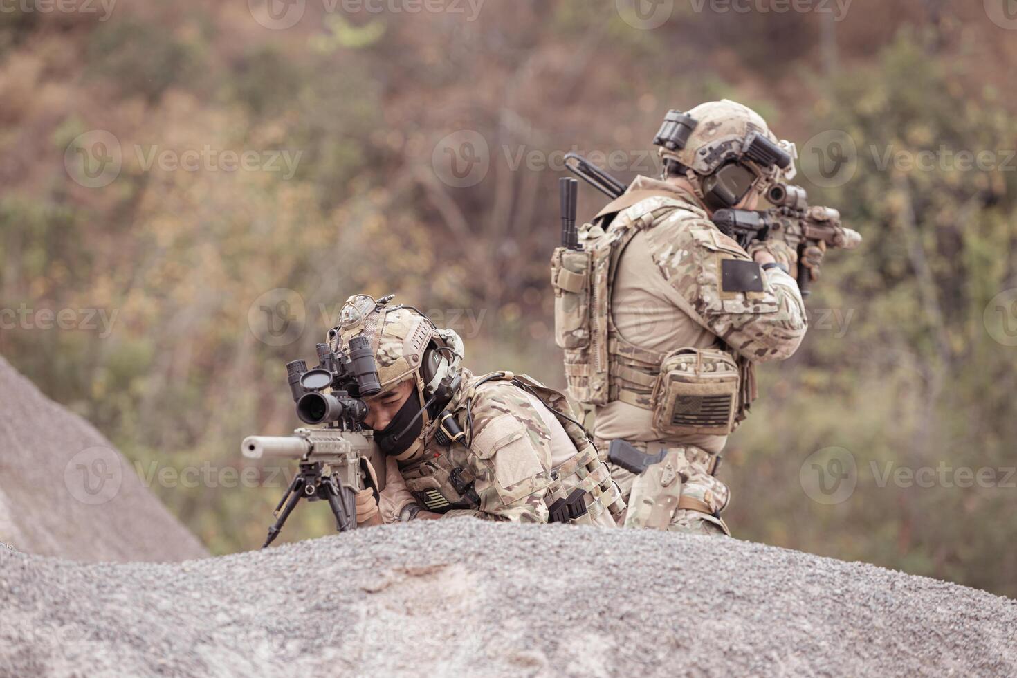 Soldiers in camouflage military uniforms carrying weapons, Reconnaissance missions in rugged mountains, Assault infantry battle training. photo