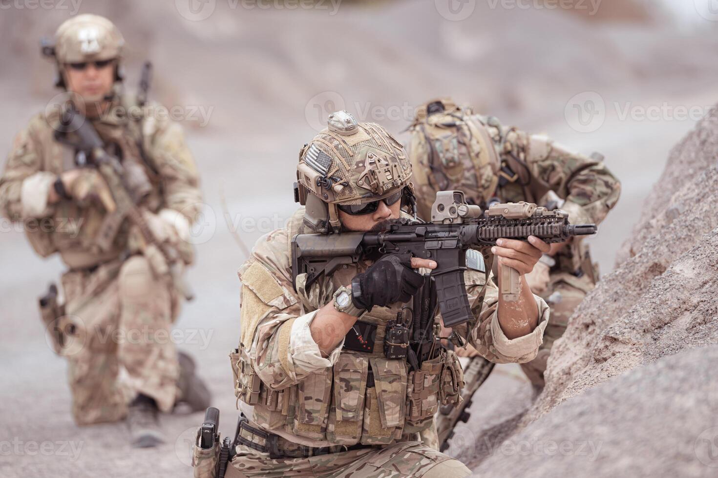 Soldiers in camouflage military uniforms carrying weapons, Reconnaissance missions in rugged mountains, Assault infantry battle training. photo