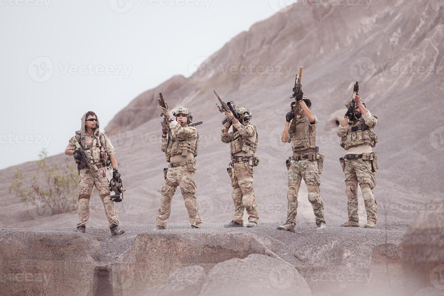 Soldiers in camouflage military uniforms carrying weapons, Reconnaissance missions in rugged mountains, Assault infantry battle training. photo