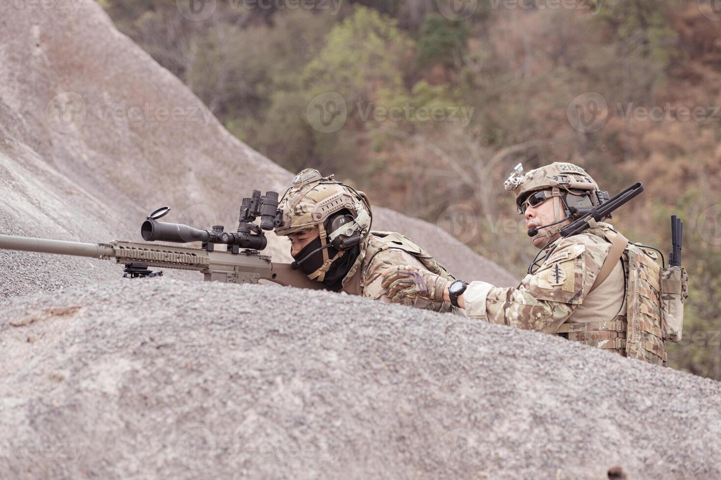 Soldiers in camouflage military uniforms carrying weapons, Reconnaissance missions in rugged mountains, Assault infantry battle training. photo