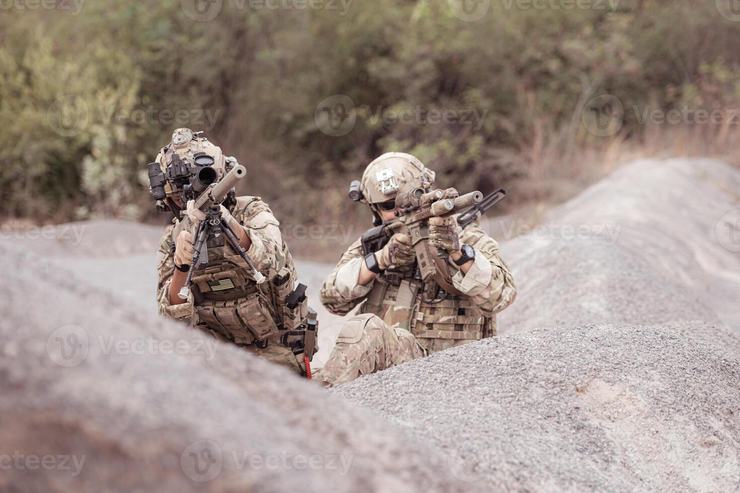 Soldiers in camouflage military uniforms carrying weapons, Reconnaissance missions in rugged mountains, Assault infantry battle training. photo