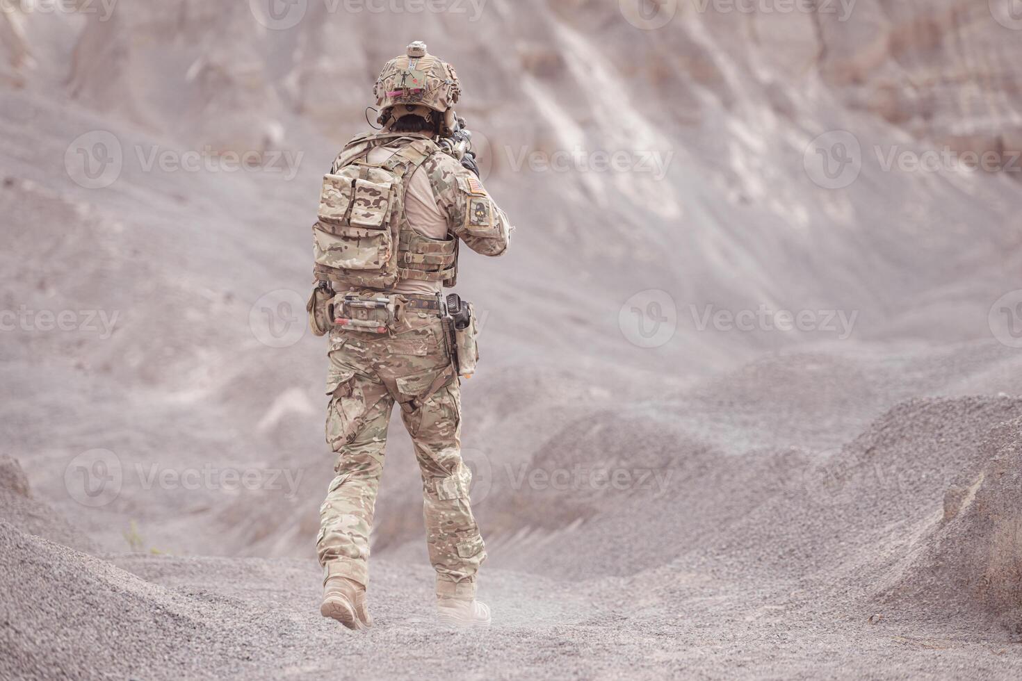 Soldiers in camouflage military uniforms carrying weapons, Reconnaissance missions in rugged mountains, Assault infantry battle training. photo