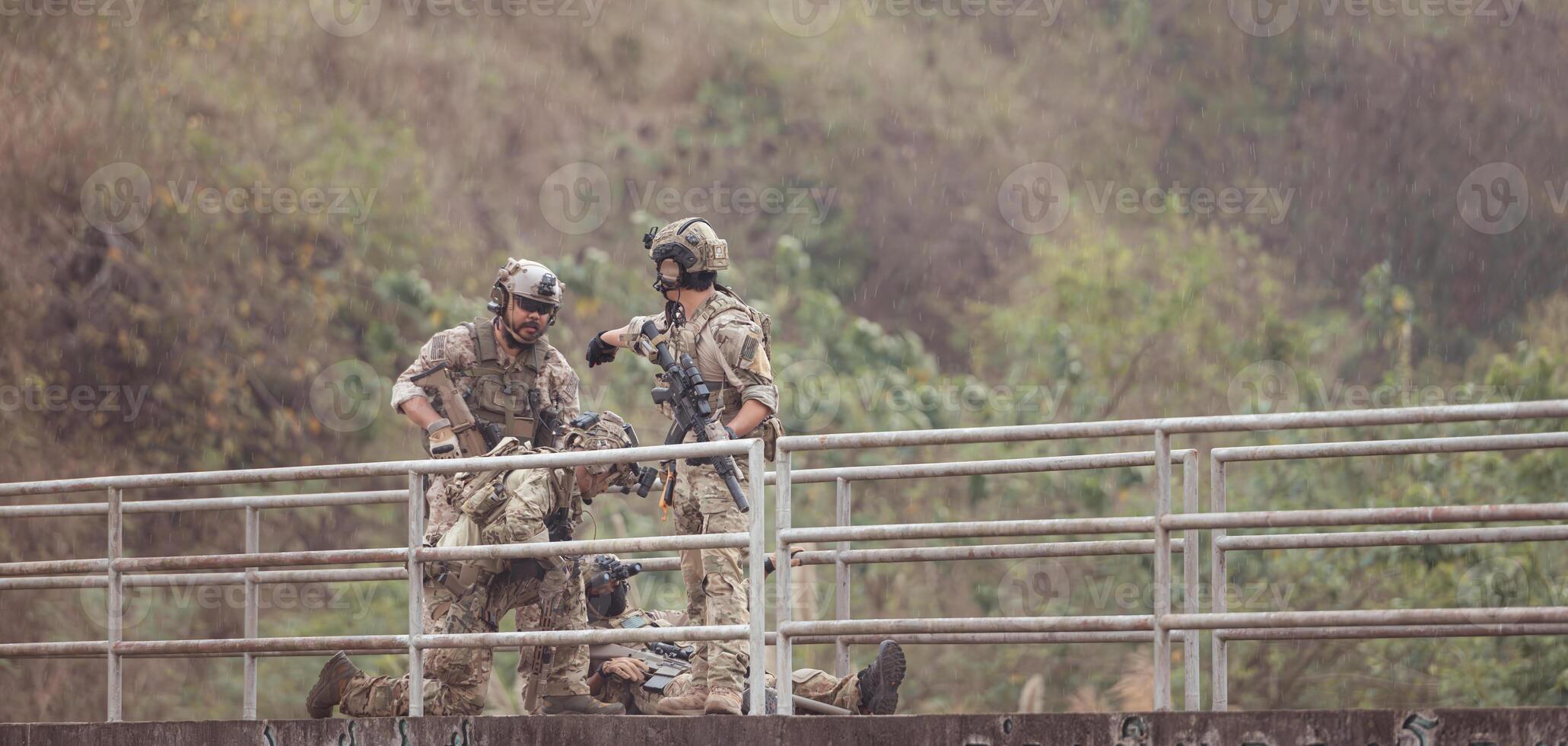 Soldiers in camouflage military uniforms carrying weapons, Reconnaissance missions in the tropical forest area, Assault infantry battle training. photo