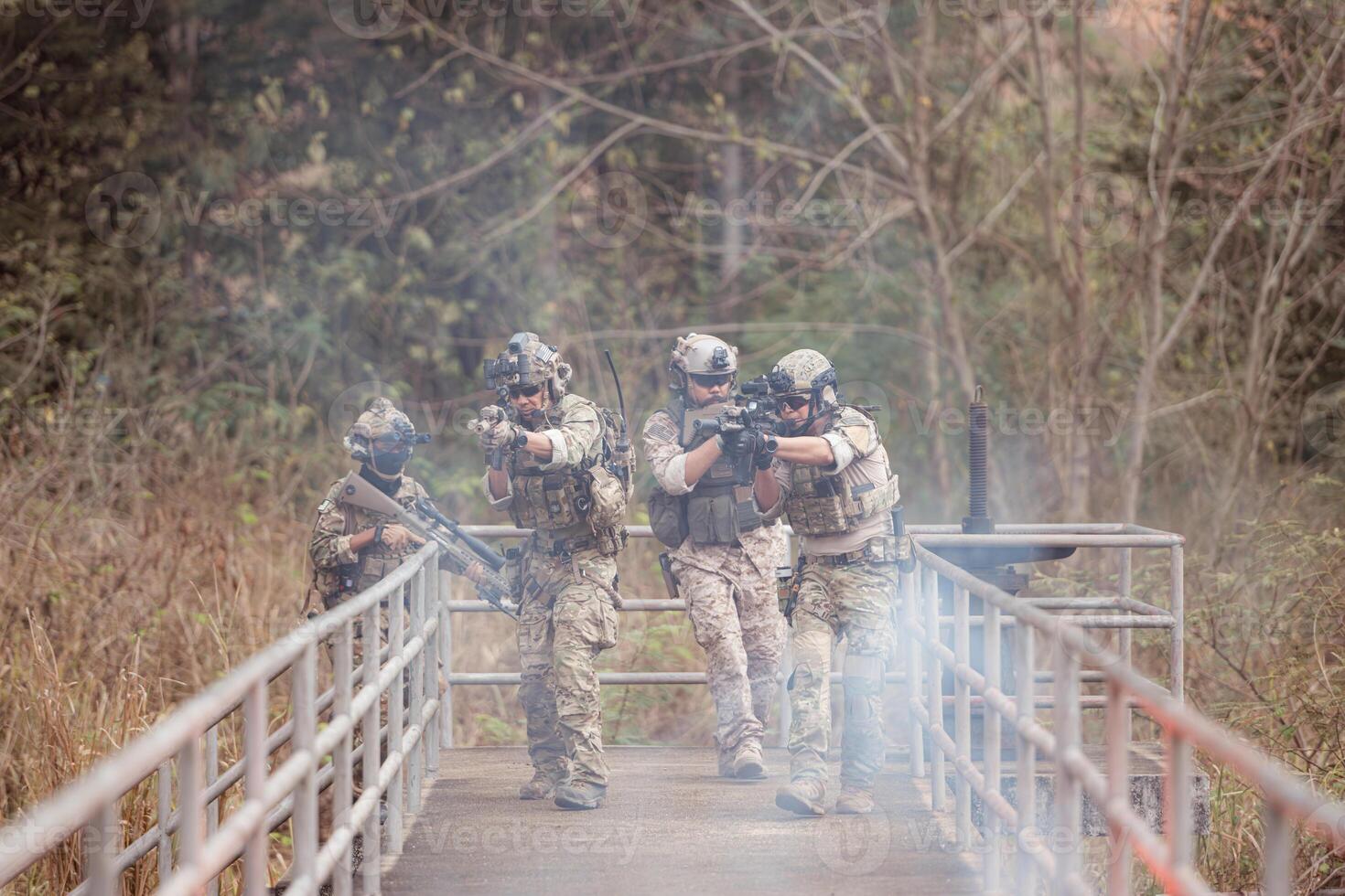 Soldiers in camouflage military uniforms carrying weapons, Reconnaissance missions in the tropical forest area, Assault infantry battle training. photo