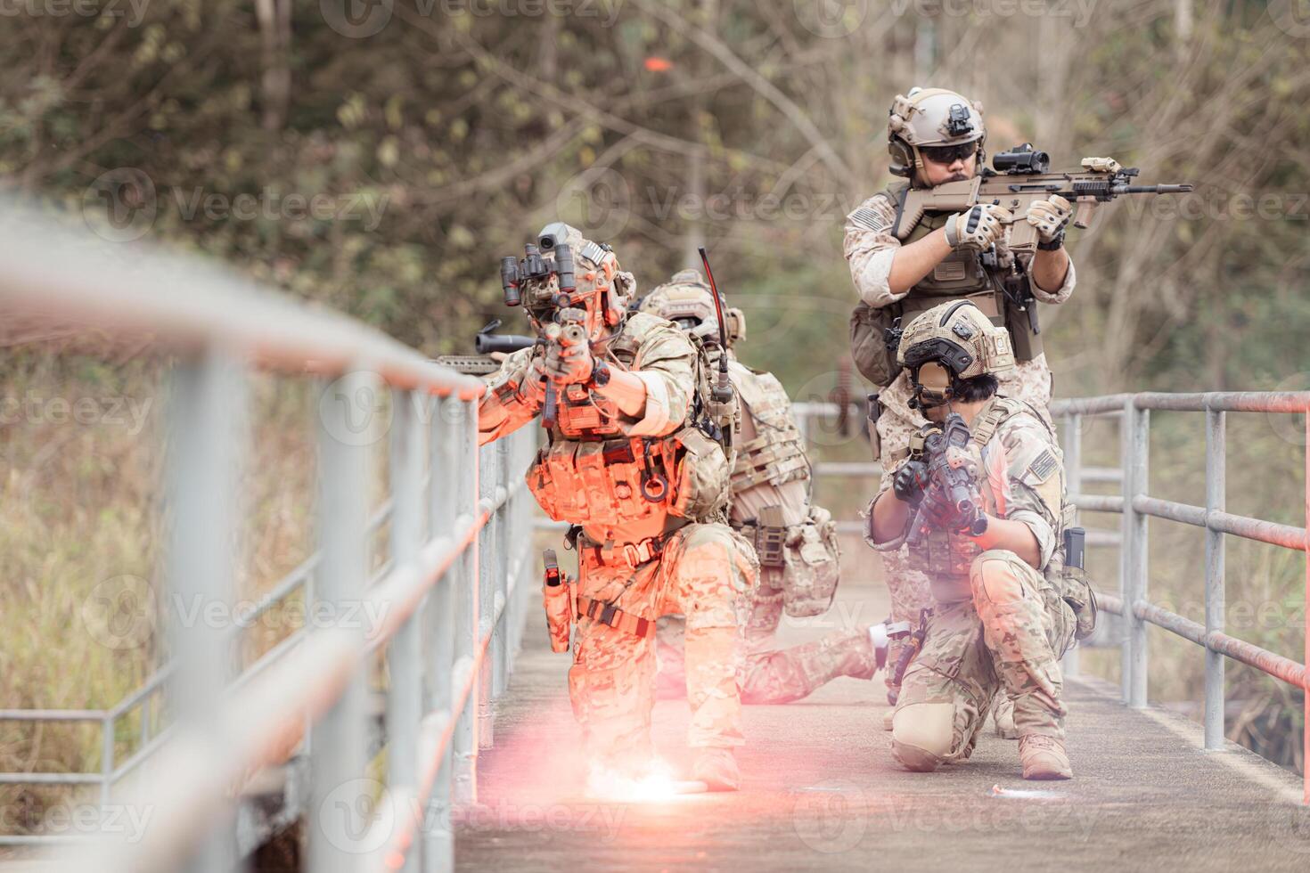 Soldiers in camouflage military uniforms carrying weapons, Reconnaissance missions in the tropical forest area, Assault infantry battle training. photo