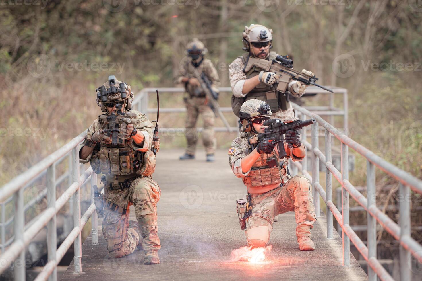 Soldiers in camouflage military uniforms carrying weapons, Reconnaissance missions in the tropical forest area, Assault infantry battle training. photo