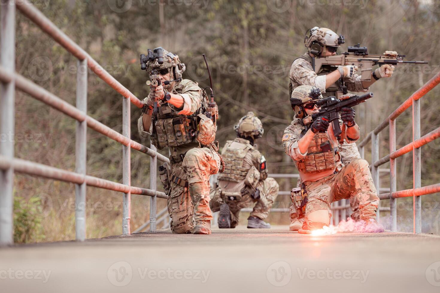 Soldiers in camouflage military uniforms carrying weapons, Reconnaissance missions in the tropical forest area, Assault infantry battle training. photo