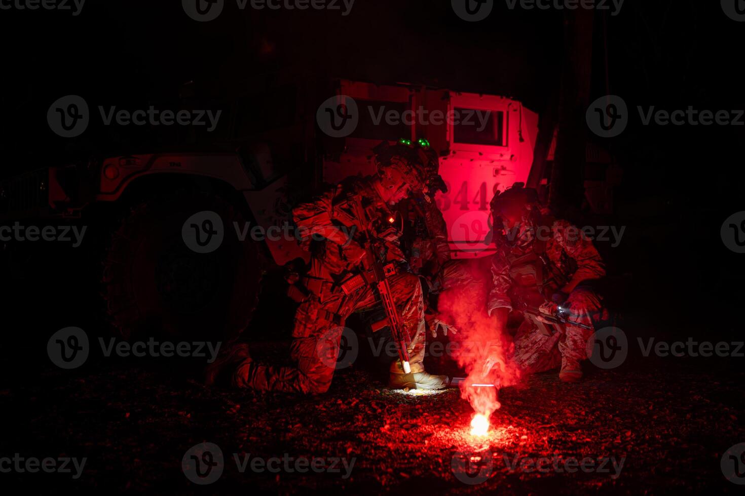 Group of soldiers in camouflage uniforms hold weapons with patrol missions at night photo