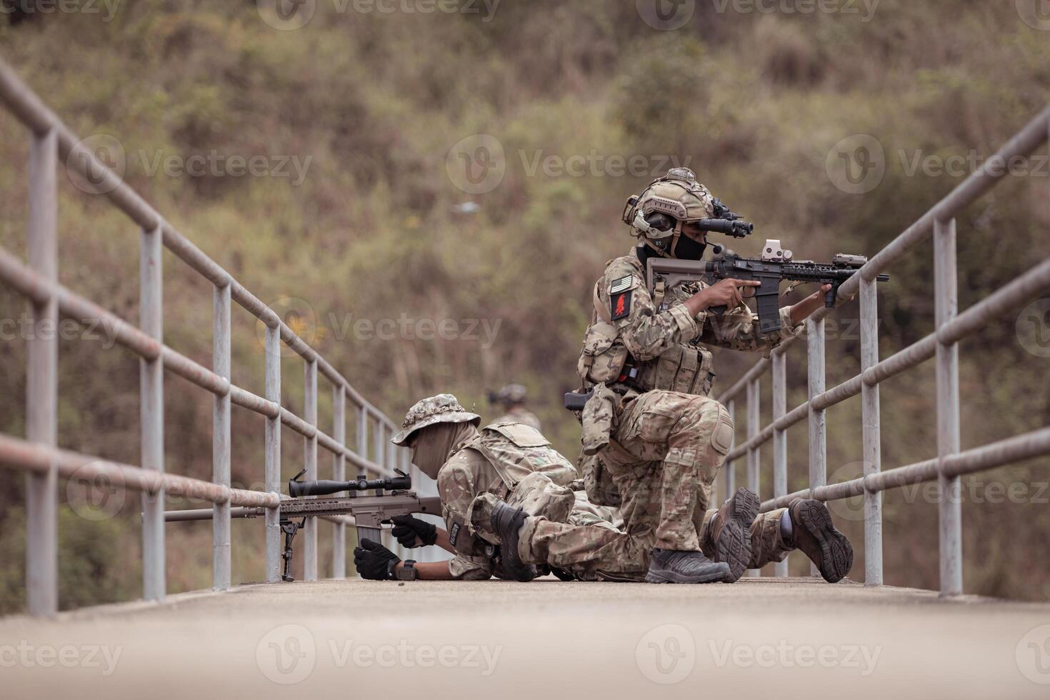 Soldiers in camouflage military uniforms carrying weapons, Reconnaissance missions in the tropical forest area, Assault infantry battle training. photo
