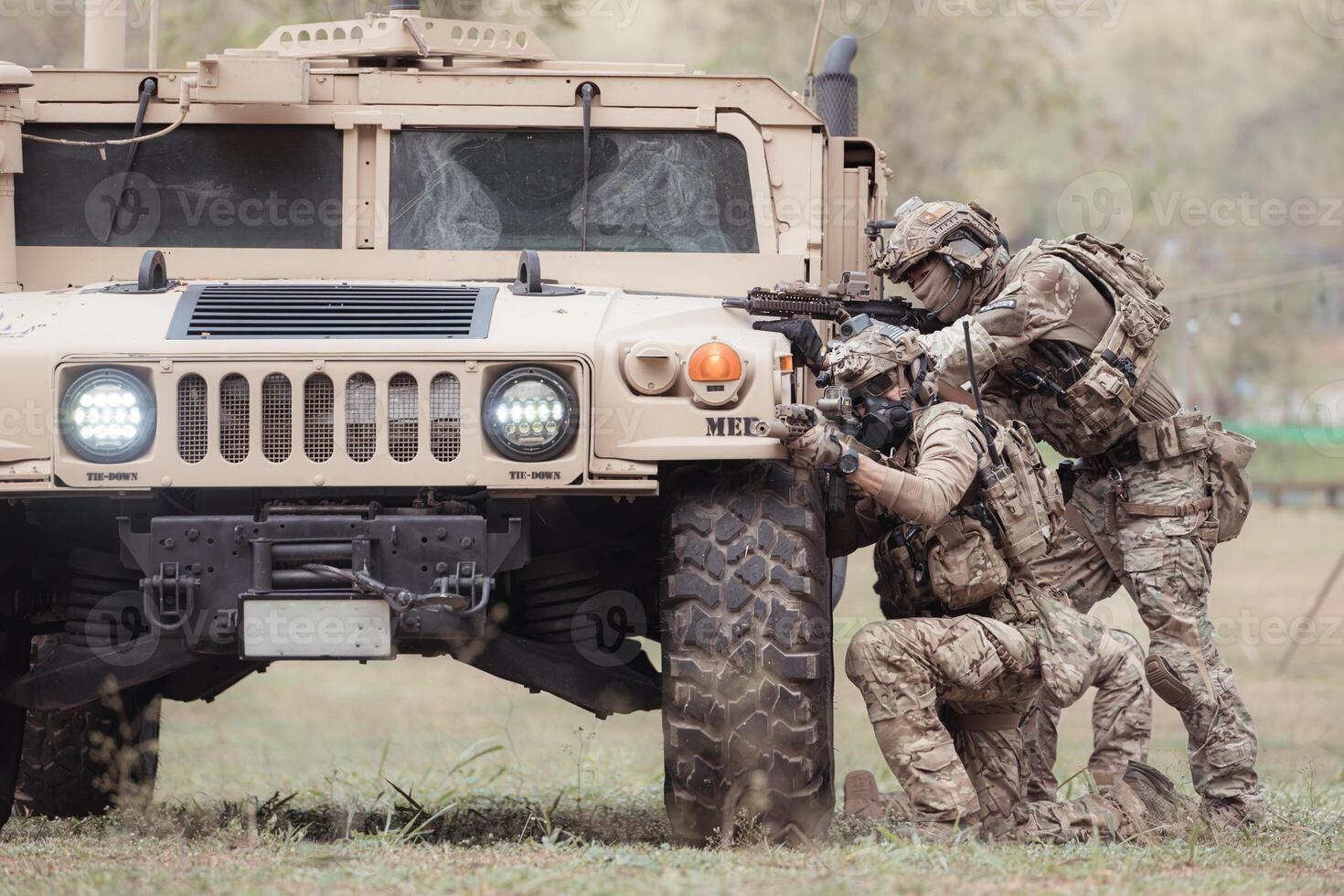 Group of soldiers in camouflage uniforms hold weapons in a jltv car, Plan and prepare for combat training. photo