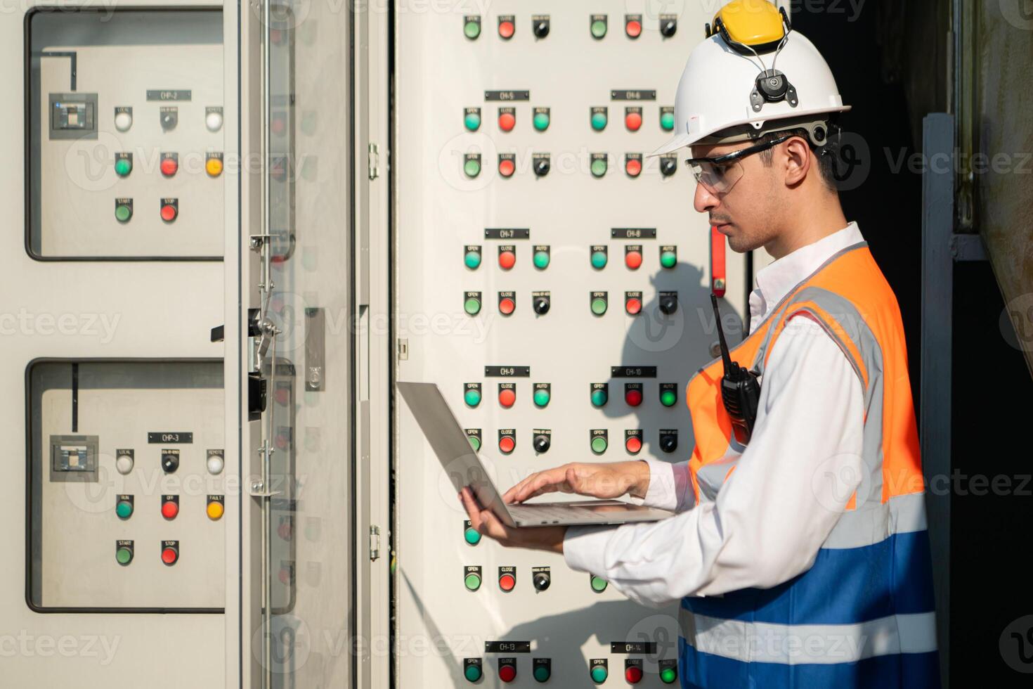 Before proceeding with the testing, Electrical engineer inspects the installed control panel. photo