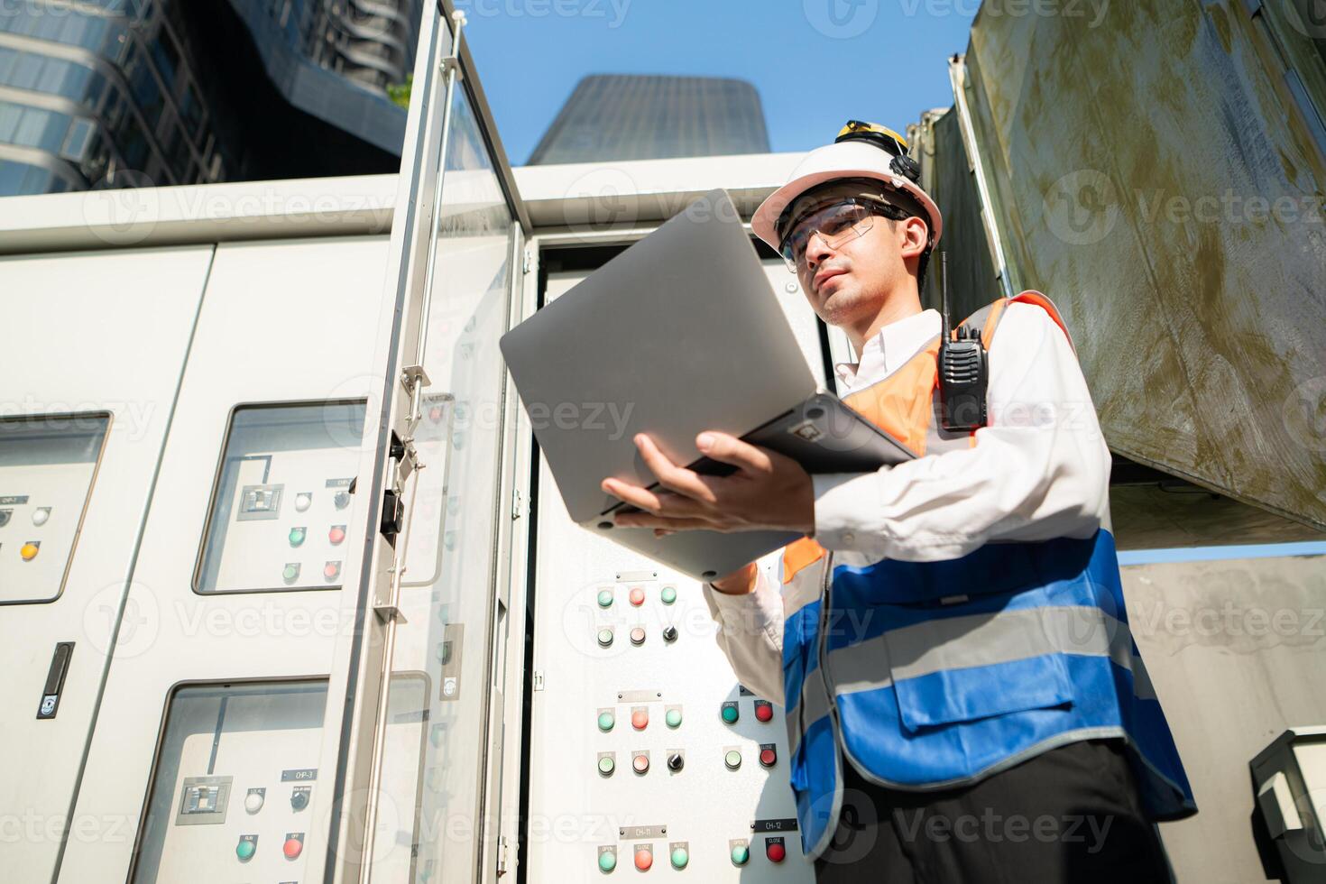 Before proceeding with the testing, Electrical engineer inspects the installed control panel. photo