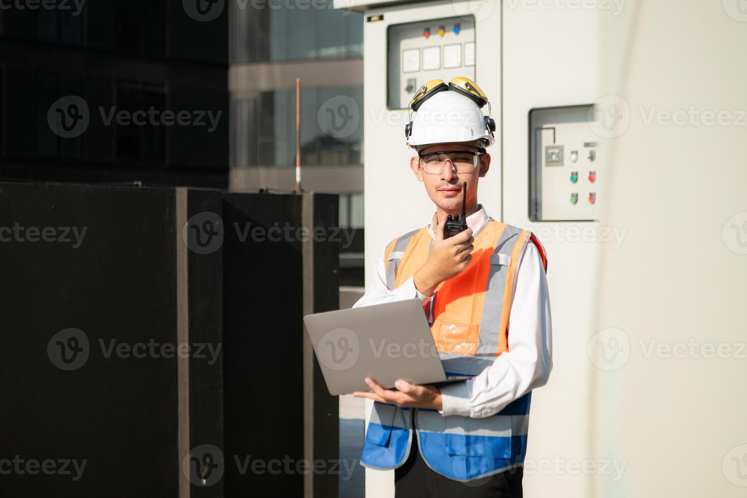 Before proceeding with the testing, Electrical engineer inspects the installed control panel. photo