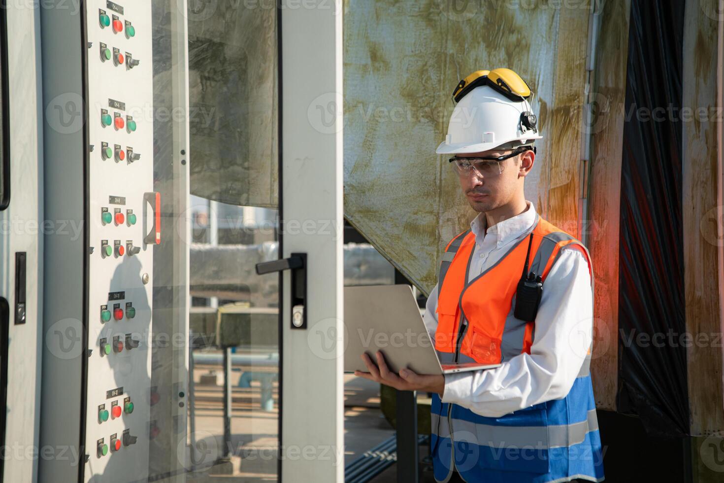 Before proceeding with the testing, Electrical engineer inspects the installed control panel. photo