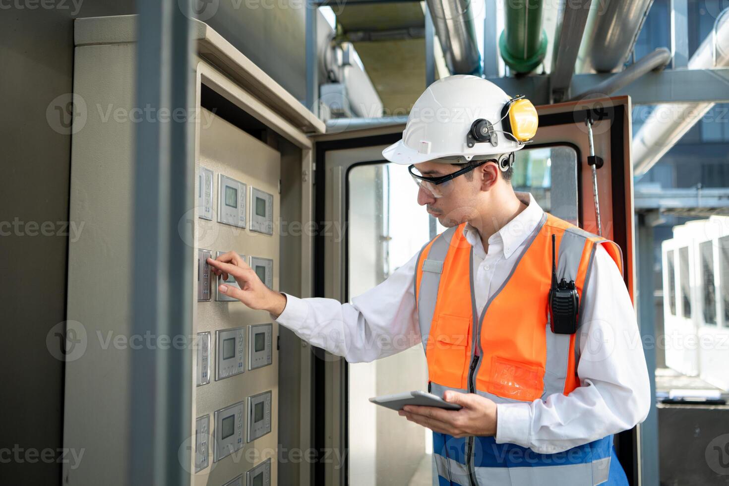 Before proceeding with the testing, Electrical engineer inspects the installed control panel. photo