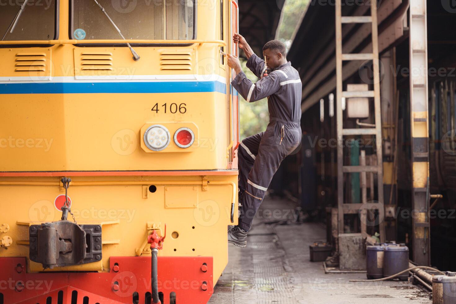 Diesel locomotive technician Inspect the train locomotive before it is used to drag train carriages to receive or transport goods and people. photo